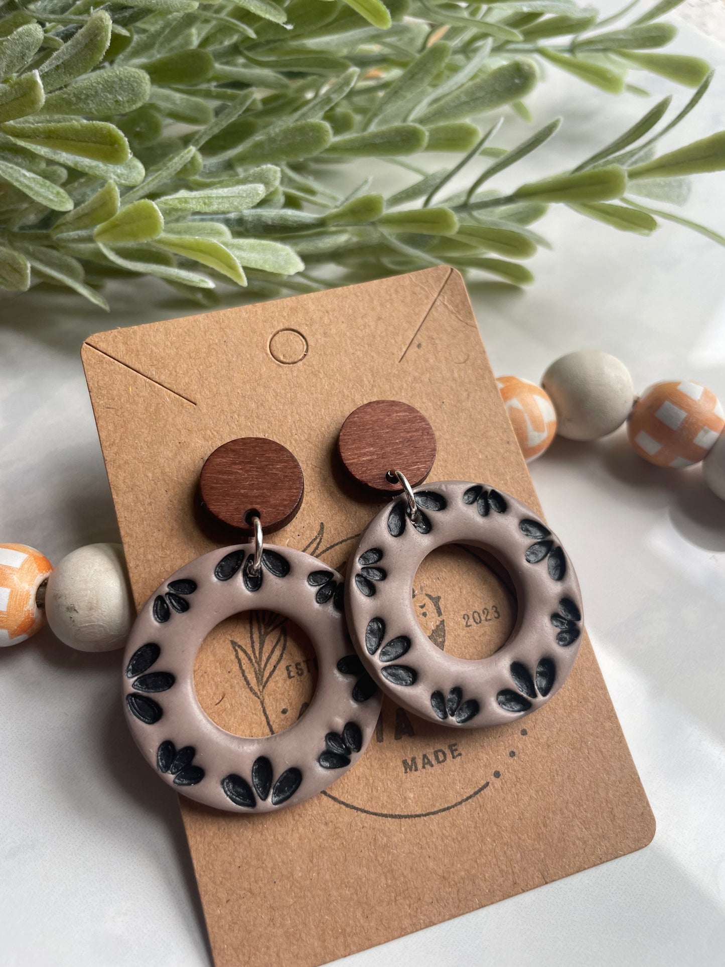 Black Floral Donut Dangle on Wood Post